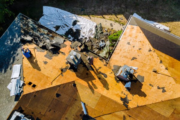 Roofer repair replace shingle that has been damaged and needing replacement of residential building