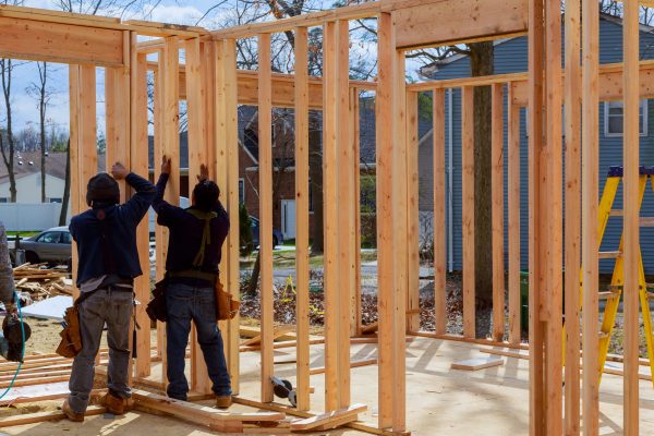 Construction Worker Building Timber Frame building, teamwork and people concept New Home